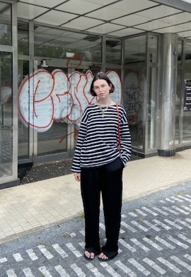 Ann Strunevskaia in a striped top on a city street