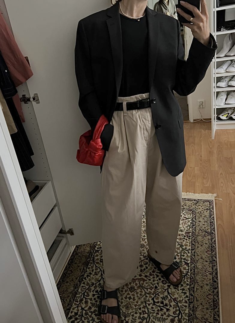After styling: black blazer outfit with cream trousers and red bag