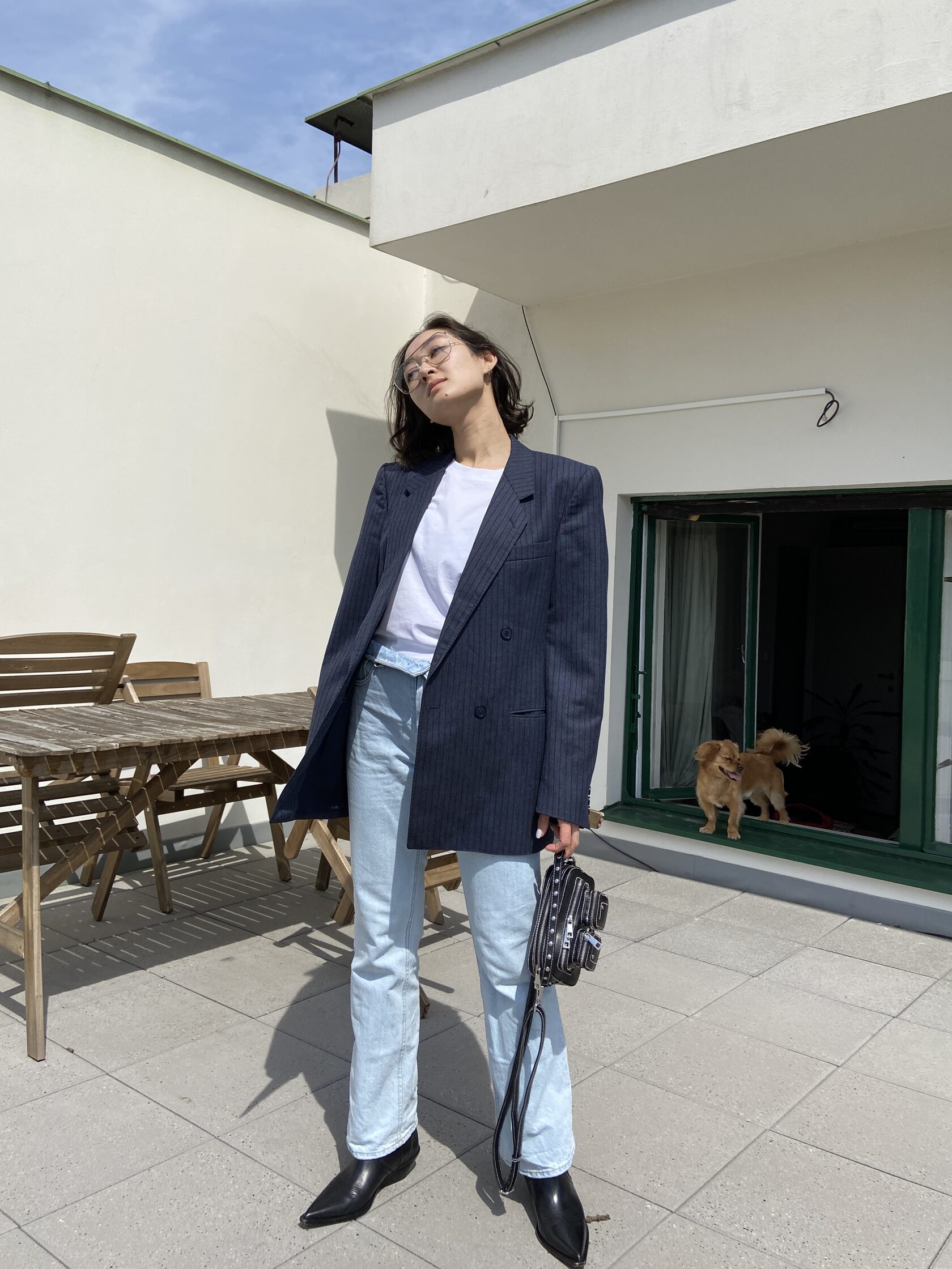 Outdoor outfit with navy blazer, light denim, and black boots