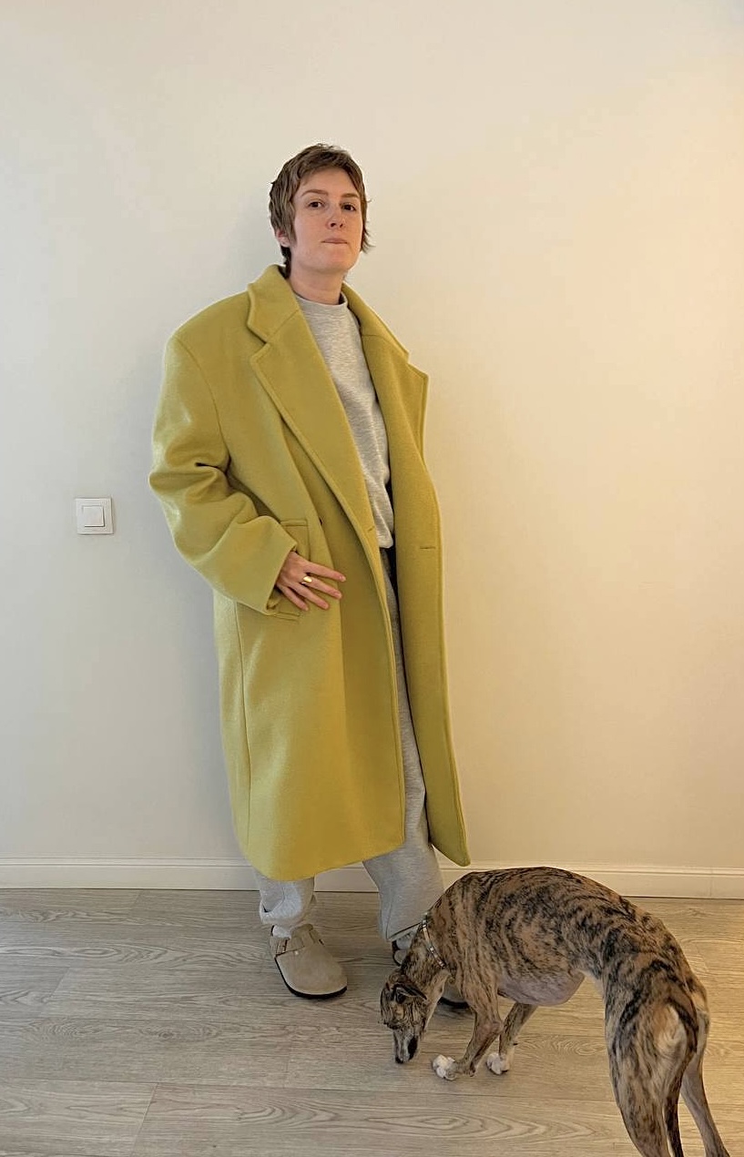 Client outfit with yellow-green coat and tonal soft layers